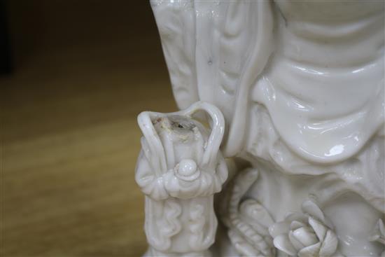 A large Chinese blanc de chine group of Guanyin and child, Kangxi period, damage and losses